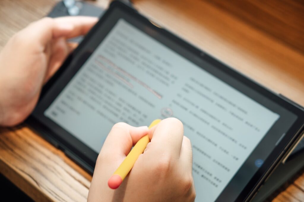 a person writing on a tablet bltd4xisdim.jpeg